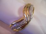 57-12 SPARKLING CRYSTALS IN GOLDTONE SWIRL BANGLE BRACELET WITH SAFETY CHAIN